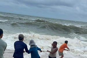 Fishermen spend hours at sea floating in plastic boxes after boat capsizes