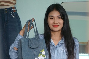 Young girl upcycles old clothes into pretty items