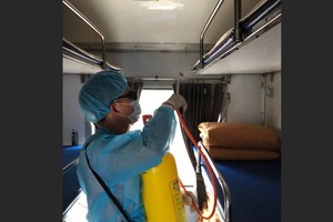 The worker disinfecting a train coach