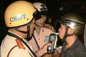Police officers check blood alcohol level of a driver 