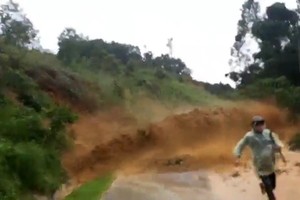 A person run out of the landslide-hit area.