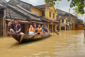 Tourists explore Hoi An ancient town on flooding days