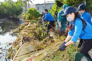 Thanh niên TPHCM tham gia dọn vệ sinh trên rạch Cây Me, quận 7 trong Ngày Chủ nhật xanh. Ảnh: VIỆT DŨNG