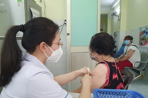 Nhân viên Trung tâm y tế quận 4 tiêm vaccine xuyên lễ cho người dân