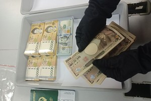 The female passenger’s money confiscated . (Picture: DAN NGUYEN)