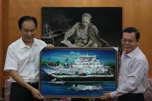 《西貢解放報》總編輯阮晉豐贈送紀念品給新華社社長蔡名照。（圖源：曉東）