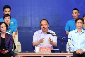 政府總理阮春福(中)在對話會上發表講話。（圖源：越通社）