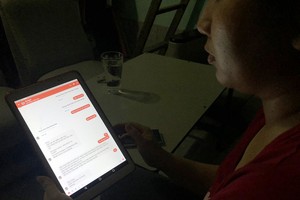 陳氏玉打開與外籍“男友”聊天記錄，向記者敘述被騙經過。