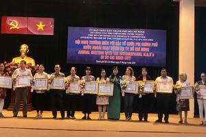 各外國非政府組織代表榮獲胡志明市人委會頒發的獎狀。（圖源：明協）