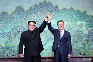 韓國防白皮書將刪“朝軍為敵”字句。圖為今年4月27日，朝鮮最高領導人金正恩與韓國總統文在寅攜手高舉，同賀簽署《板門店宣言》。（圖源：AFP）