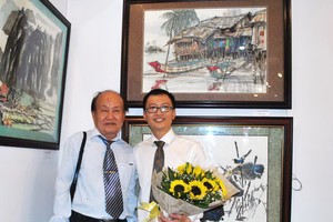優秀藝人張路書畫家（左）與畫壇新秀馬鴻山在《金甌五根》畫作 前合照。