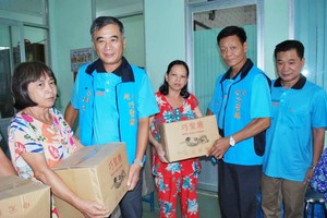 本報與巧聖廟配合在第十一郡第十四坊派發禮物。