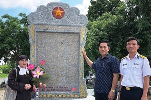 慶和省長沙島縣代表接受駐韓國越南佛子協會寄送的銘記葛麻島戰士紀念碑。（圖源：文玉）