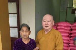 釋惟鎮法師派發禮物給貧戶。