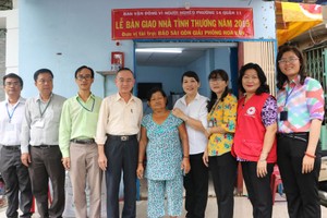 范興主任(左四)與地方領導同張南瑛(中) 在屋前留影。