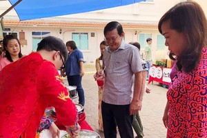 阮晉豐總編輯品嚐本報員工烹飪的華人美食。