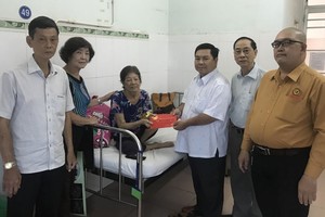 梁玉燕感激地接過顧問會贈送的慰問金。