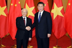 黨中央總書記、國家主席阮富仲（左）與中共中央總書記、中國國家主席習近平。（圖源：越通社）