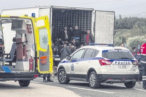 警方在公路上查獲運載非法移民冷凍車。（圖源：AFP）
