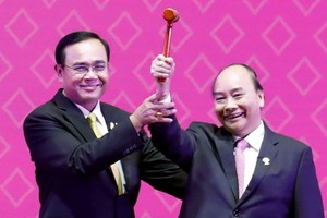 阮春福總理（右）從泰國總理巴育手中接過象征東盟輪值主席國身份的木槌。（圖源：VGP）
