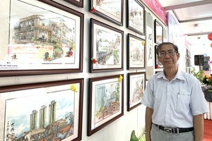 黃賢偉畫家與在“時令之美”個展中的堤岸老街景作品。