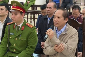 被告人張明俊手持話筒回答審判員問案。（圖源：嘉慶）