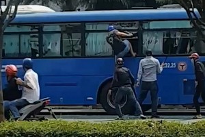 約有4至6人的青年團夥手持銳器和棍棒兇狠砸破巴士擋風鏡及側窗玻璃鏡。（圖源：視頻截圖）