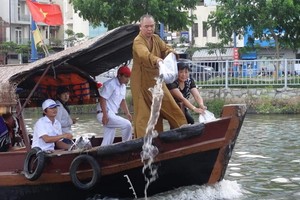 釋慧功法師在豆腐涌放魚苗。