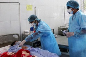 醫生給隔離病房裡的患者看診。