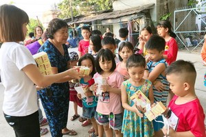 阮氏成給租房工人的孩子派發口罩。