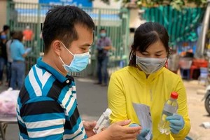 第十郡第十四坊婦女會成員向隔離區居民贈送抗菌洗手液並引導如何正確且有效使用洗手液。