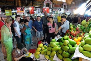 遊客參觀濱城市場的水果攤。（圖源：VNA）