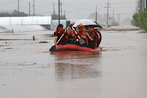 圖為3日天安市村民搭乘橡皮筏脫困。（圖源：韓聯社）