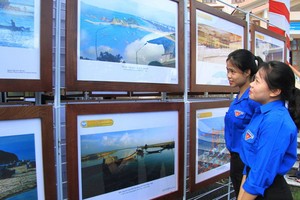 年輕人參觀了解“越南的黃沙與長沙群島-歷史證據與法理依據”地圖與資料展。（圖源：鄧俊）