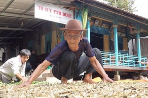 七漢老翁曬藥材以送給慈善診所。