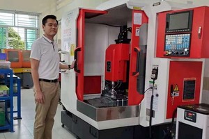 紅心企業經理劉成發攝於新添購的CNC機器。