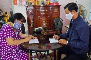 郵局人員上門給退休幹部轉付退休金。