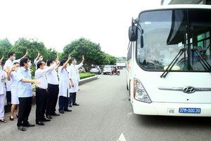 乂安省全科友好醫院醫護人員向車上馳援河靖抗疫的志願醫護幹部團揮手告別。（圖源：越通社）