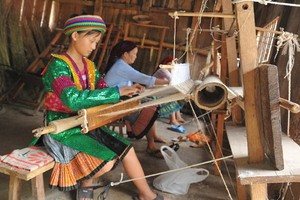 一名少數民族少女採用傳統手工方式編織麻布。（圖源：河江報）