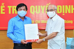 市委宣教處主任潘阮如奎（右）向曾友鋒同志頒授委任《決定》。