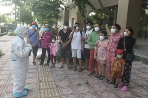 一家三代同堂的十一口人戰勝病魔一同出院之前聆聽醫護人員的囑咐。（圖源：絨阮）