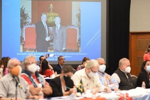 阮富仲總書記的賀信在研討會上播放。（圖源：越通社）