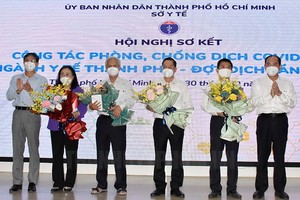 市衛生廳領導向為本市疫情防控工作做出巨大貢獻的專家獻花表示感謝。（圖源：市黨部新聞網）