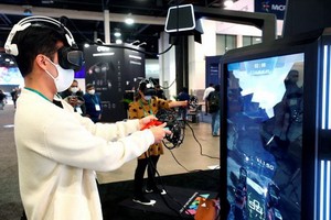 1月5日，在2022年美國拉斯維加斯消費電子展（CES）上，參觀者體驗一款虛擬現實（VR）電子遊戲。（圖：新華社/路透社）