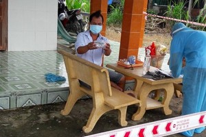 前江省醫療工作人員為一名居家治療的新冠患者上門查體送藥。（圖：朱偵）