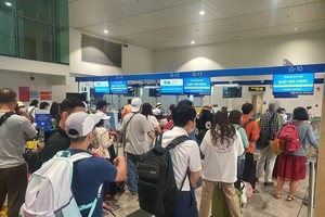 乘客在機場排隊辦理登機手續。