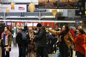 2022 年12月23日，乘客在法國巴黎的 Gare Saint Lazare 火車站查看信息面板。（圖：新華社）