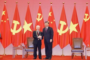 中共中央总书记、国家主席习近平向党中央总书记阮富仲授予中华人民共和国“友谊勳章＂。（图：越通社）