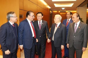 党中央总书记阮富仲与党政领导、原领导交谈。（图：越通社）