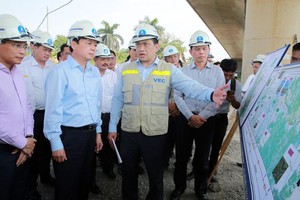 政府副总理陈红河（前左二）在听取该项目管委会负责人的施工进度汇报。（图：VGP）